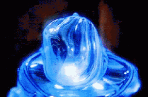 a close up of a blue condom with a black background