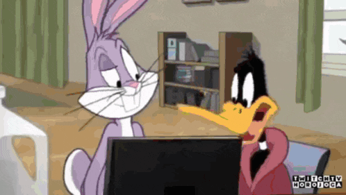 bugs bunny and daffy duck from looney tunes are sitting in front of a laptop