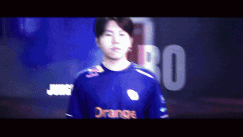 a man wearing a blue jersey with orange on the front
