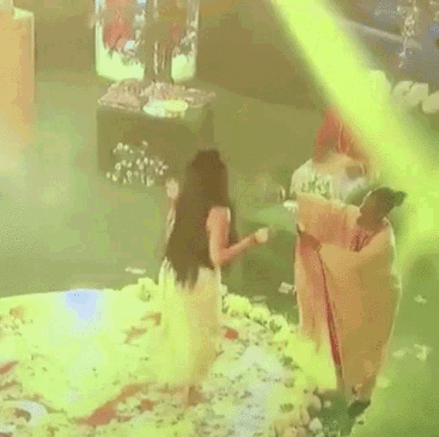 a woman in a red dress is standing next to a man in a red robe .