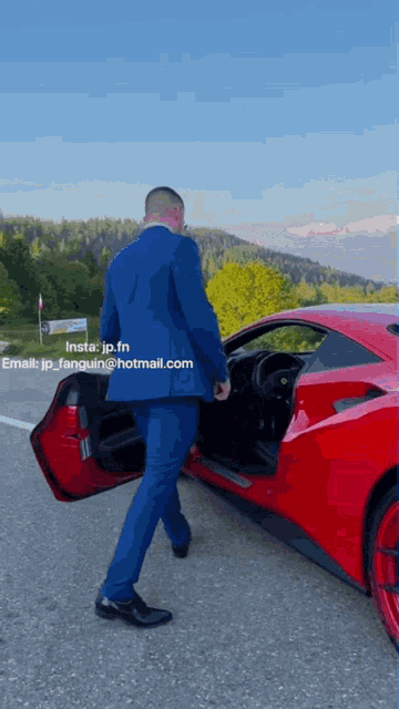 a man in a suit is walking towards a red sports car