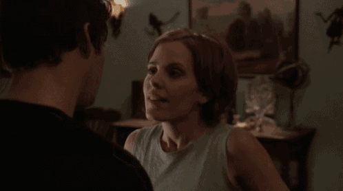 a man and a woman are looking at each other and smiling