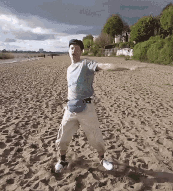 a man standing on a beach with his arms out