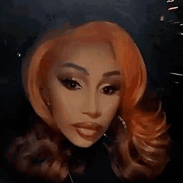 a close up of a woman 's face with orange hair and earrings .