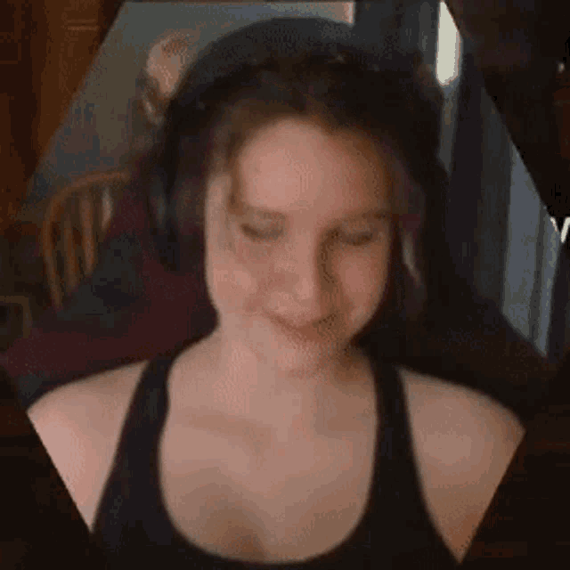 a woman wearing headphones is sitting in a chair .
