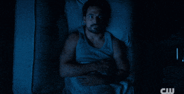 a man and a woman are laying next to each other in a bed with a cw logo in the corner