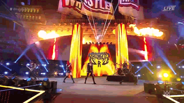 a group of people on a stage with a sign that says ' wrestlemania ' on it