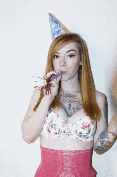 a woman wearing a party hat that says happy birthday on it