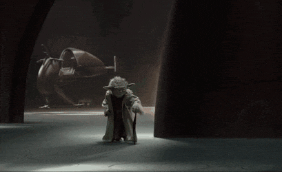 a statue of yoda with a cane standing in a dark room