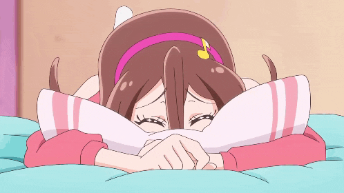 a girl with a pink headband is laying on a bed with her head on a pillow