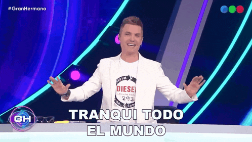 a man wearing a diesel 293 shirt stands in front of a sign that says tranquil todo el mundo