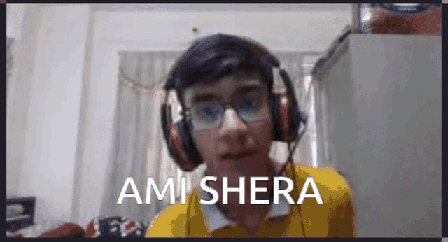 a man wearing headphones and a yellow shirt says ami shera on the screen