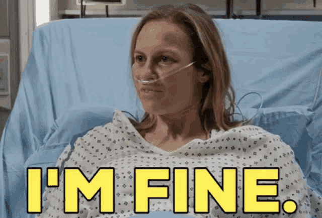 a woman in a hospital bed with the words i 'm fine written above her
