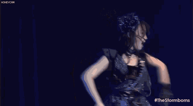 a woman is dancing on a stage with the hashtag #thestormborns on the bottom