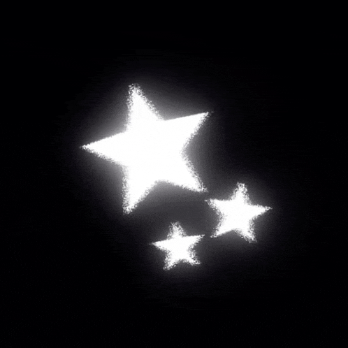three white stars are floating in the air on a black background .