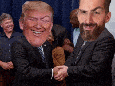 a man in a suit and tie shakes hands with a man in a beard