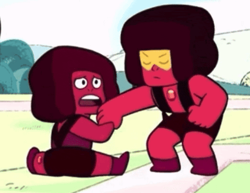 a couple of red cartoon characters standing next to each other on a track .