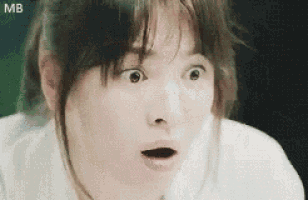 a close up of a woman 's face with her mouth open .