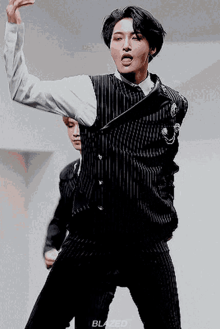 a man in a suit is dancing with the word blazed on the bottom right corner