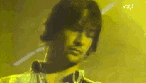 a close up of a man 's face with a yellow background
