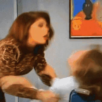 a woman is holding a child in a wheelchair in front of a painting on the wall