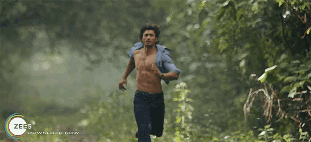 a man without a shirt is running through a forest with a zee5 download now advertisement behind him