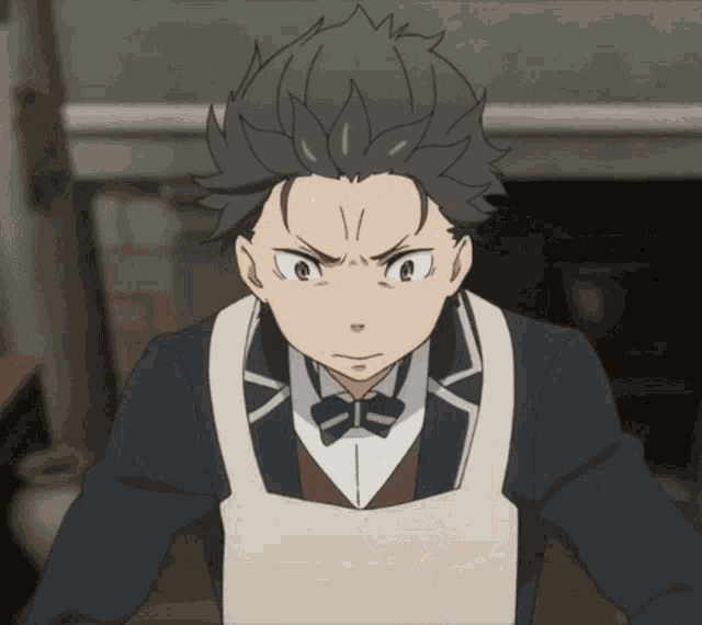 a man in a tuxedo and apron has a very angry look on his face