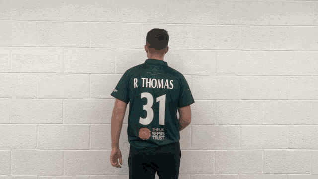 a man wearing a green shirt that says integrity