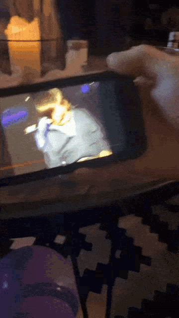 a person is playing a video game on a phone