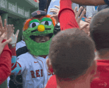 a man wearing a sesame street mask with the word rei on his jersey