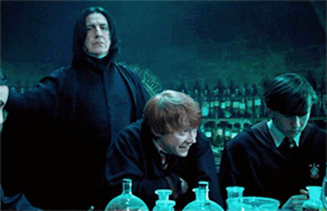 a group of harry potter characters are gathered around a table with beakers and flasks
