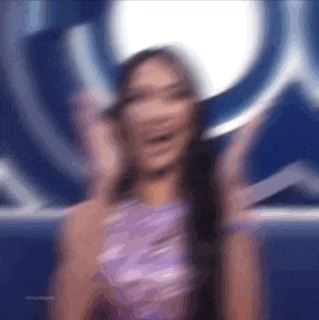 a blurry picture of a woman wearing a purple dress .