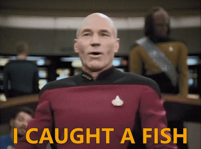 a man in a red uniform says i caught a fish in yellow letters