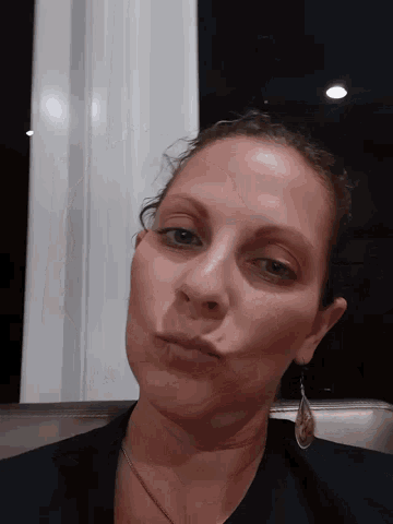 a close up of a woman 's face with a black shirt on