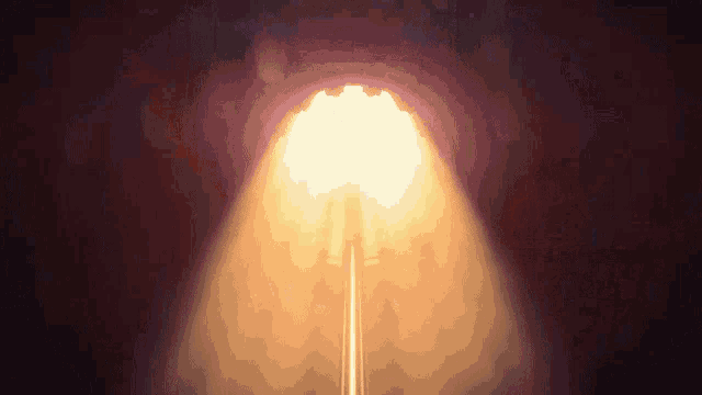 a bright light is coming out of the end of a tunnel