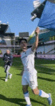 a soccer player in a white jersey with the number 23 on the back