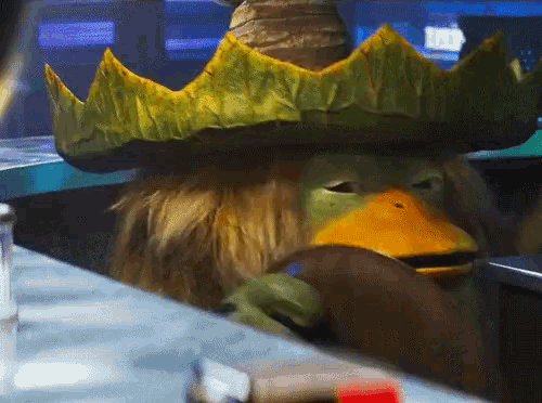 a cartoon character wearing a green hat and a yellow duck head