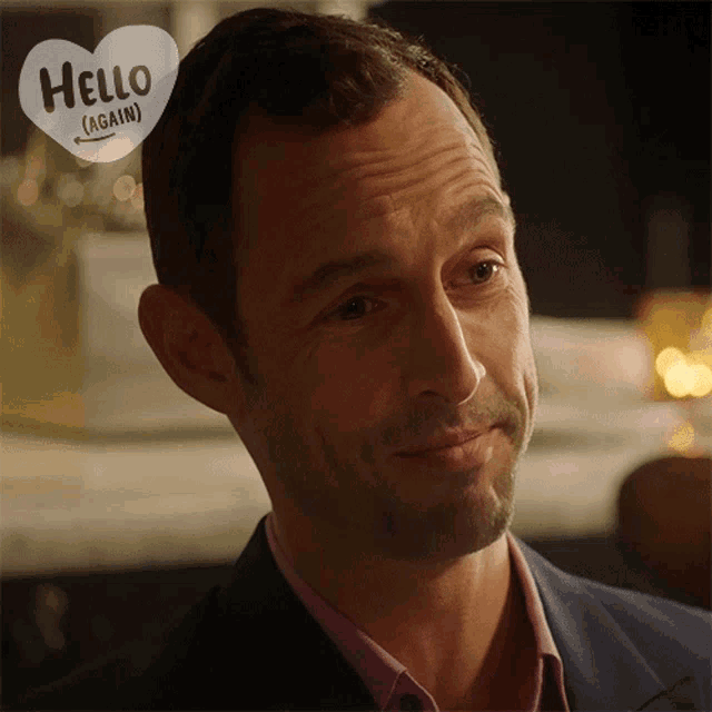 a man with a heart that says hello ( again ) on it