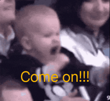 a baby is screaming in a crowd with the words come on !!! behind him