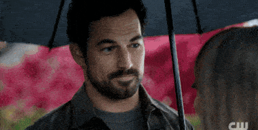 a close up of a woman looking at a man with the word cw in the corner