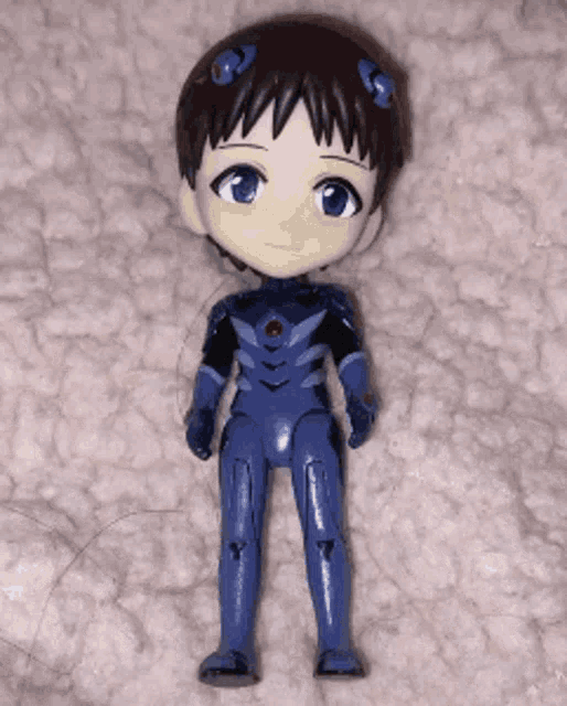 a figurine of a boy in a blue suit