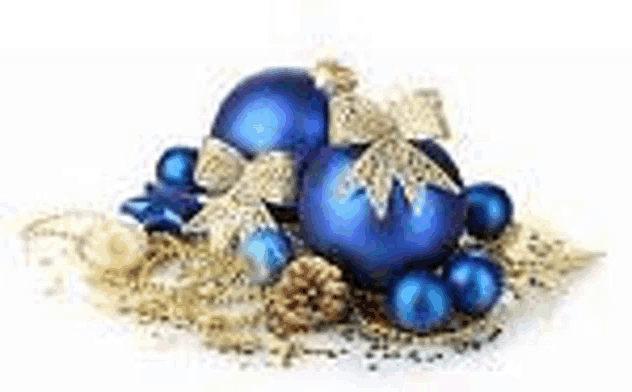 a pile of blue and gold christmas decorations on a white surface .