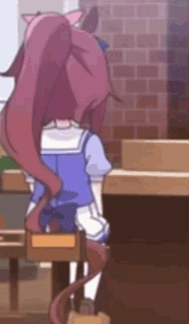 a girl with long red hair is sitting in a chair in a room .