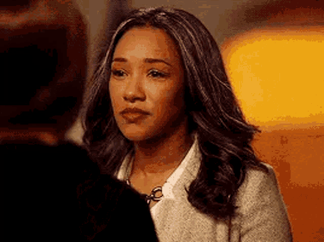 a woman is looking at another woman in a room .