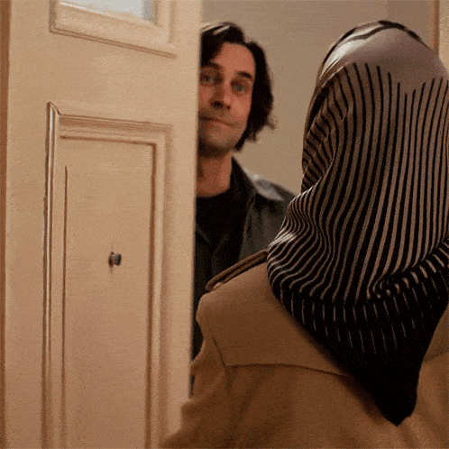 a man and woman are standing in a doorway