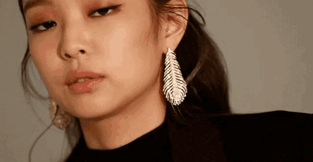 a close up of a woman wearing earrings .