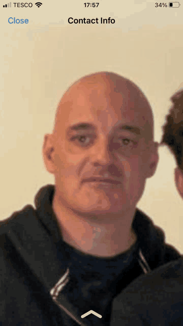 a close up of a man 's face on a phone screen with the time of 17:47