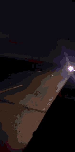 a car is driving down a highway at night with purple lights