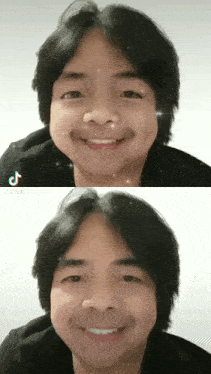a man with a mustache is smiling and has a tiktok sticker on his head