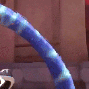 a person is playing a video game in a living room with a blue snake in the background